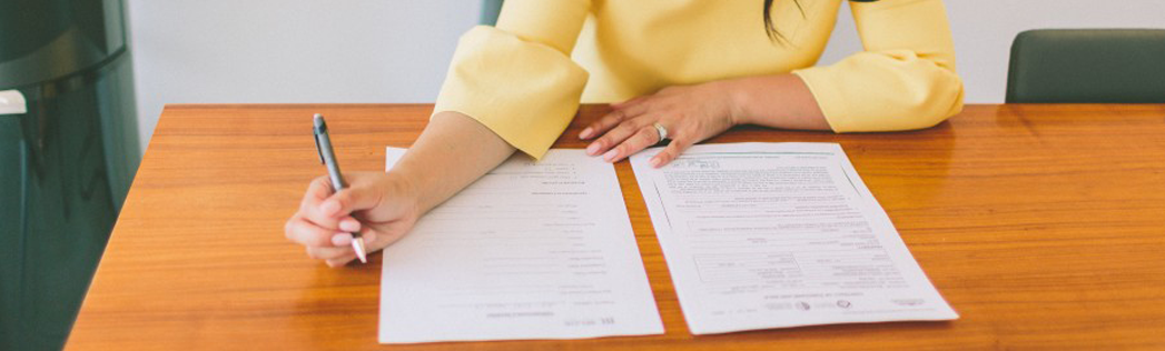 Women writing agreements on paper